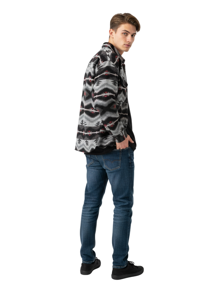 Man wearing a patterned shirt and jeans on a white background