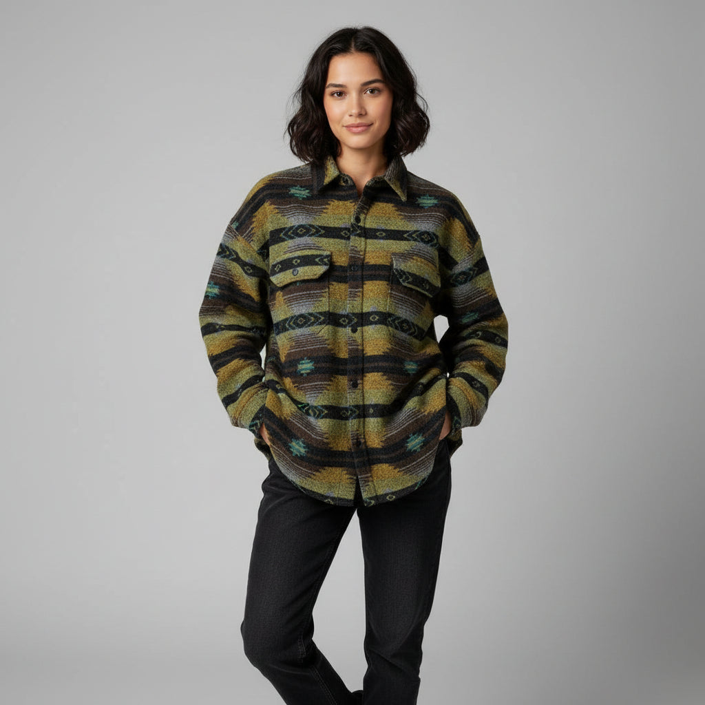 Woman wearing a patterned shirt with a plain background