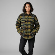 Woman wearing a patterned shirt with a plain background