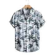 Short-sleeve shirt with tropical leaf pattern on a hanger against a white background